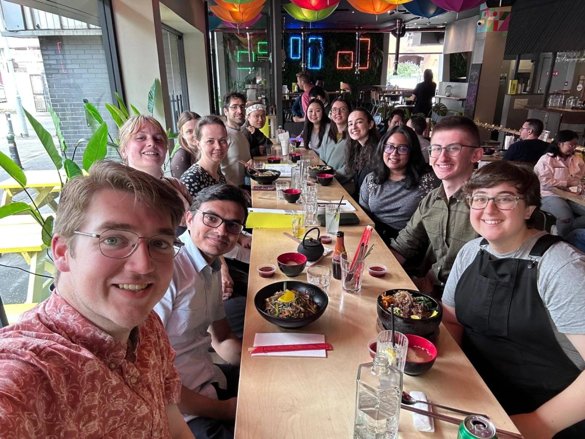 A large group of people around a table at a restaurant