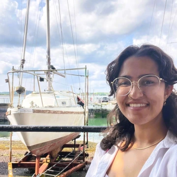 Arpita standing in front of a ship in dry dock in Cobh